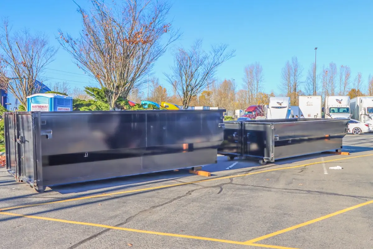 Professional dumpster rental service with roll-off container on residential driveway in Passaic